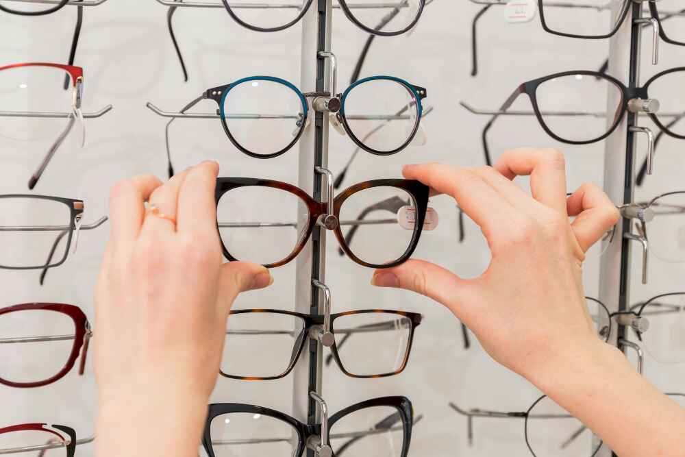 close-up-woman-hand-removing-eyeglasses-from-display